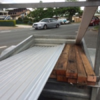 Collecting the hardwood and tin from the recycled building supplies place